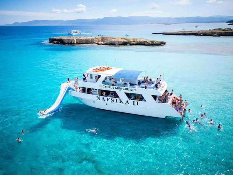 BBQ Boat: Nafsika II Sunset BBQ, Waterslide & Swimming Trip - Coastal views, caves, and named stops