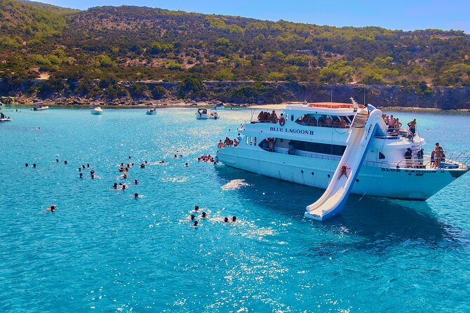 Blue Lagoon (Akamas) Bus & Boat Tour with Water Slide From Paphos - Fruit, drinks, and music round out the return trip