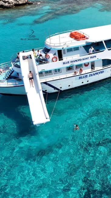 Blue Lagoon Cruise: Waterslide Adventure from Latchi Harbour - Music, atmosphere, and the onboard bar