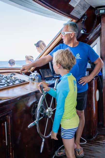 Paphos Blue Lagoon Cruise: Slide, Music & Hotel Transfer - Fruit, wine, music, and the onboard bar