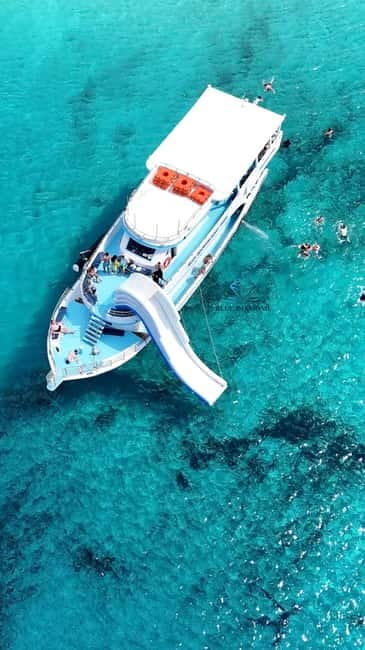 Paphos Blue Lagoon Cruise: Slide, Music & Hotel Transfer - Boarding at Latchi and settling into the boat